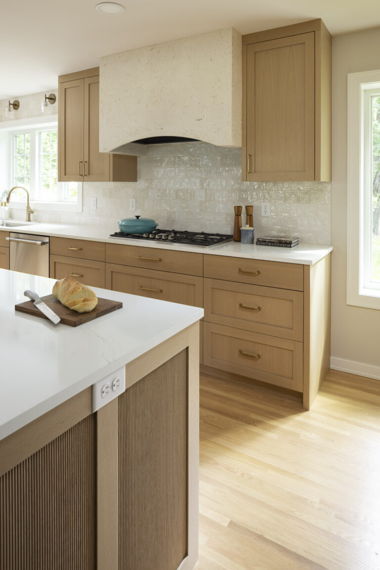 AMEK Bloomington kitchen remodel with plaster range hood, reeded panels on island