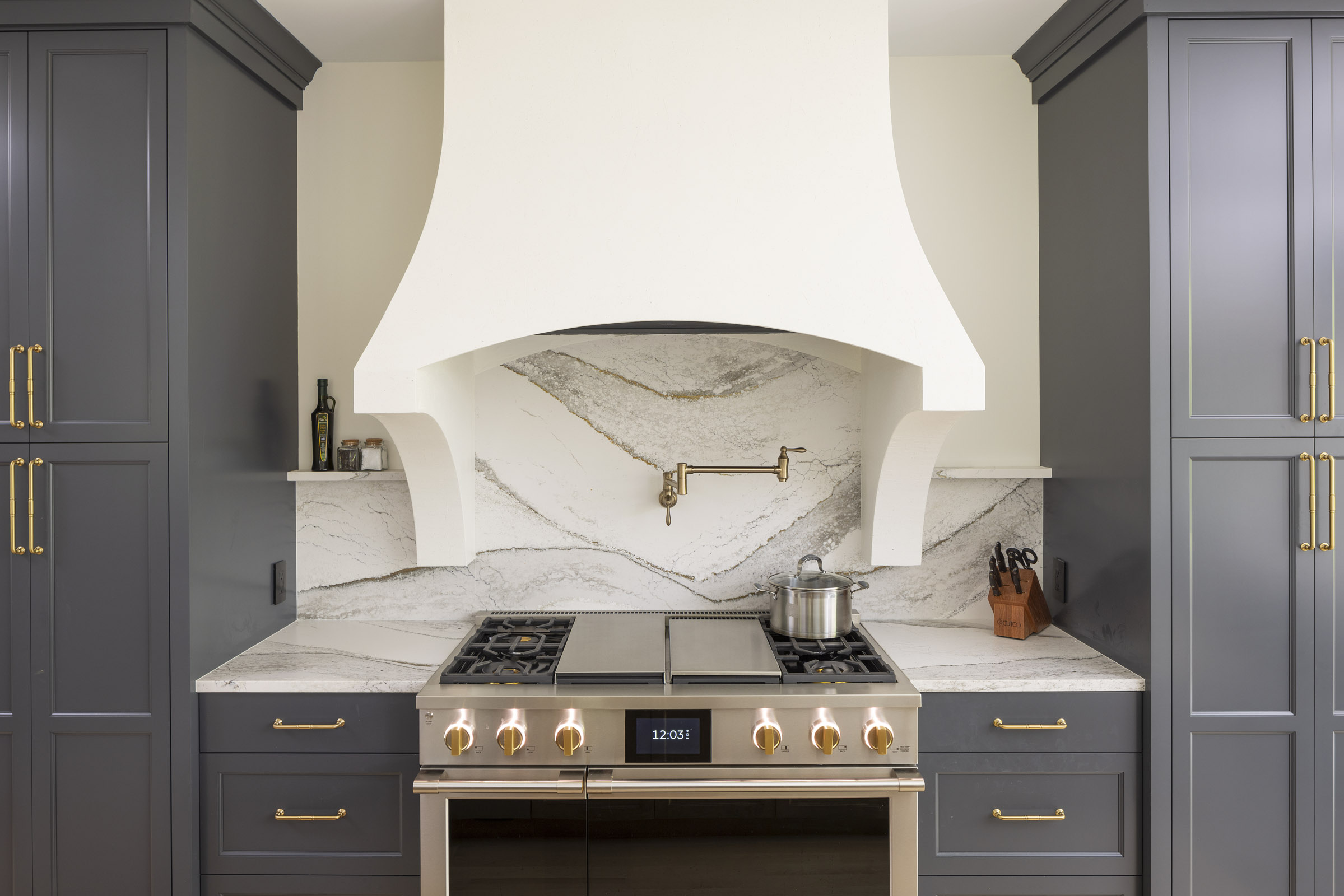 AMEK Inver Grove Heights kitchen remodel with professional level appliances, Cambria backsplash, and custom plaster range hood.