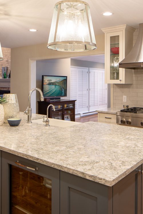 AMEK-Edina-Kitche-to-Living-Room-2018-75 View from a large granite kitchen island into an open-concept living room with white and grey cabinets. Part of a main level remodel in Edina, MN.